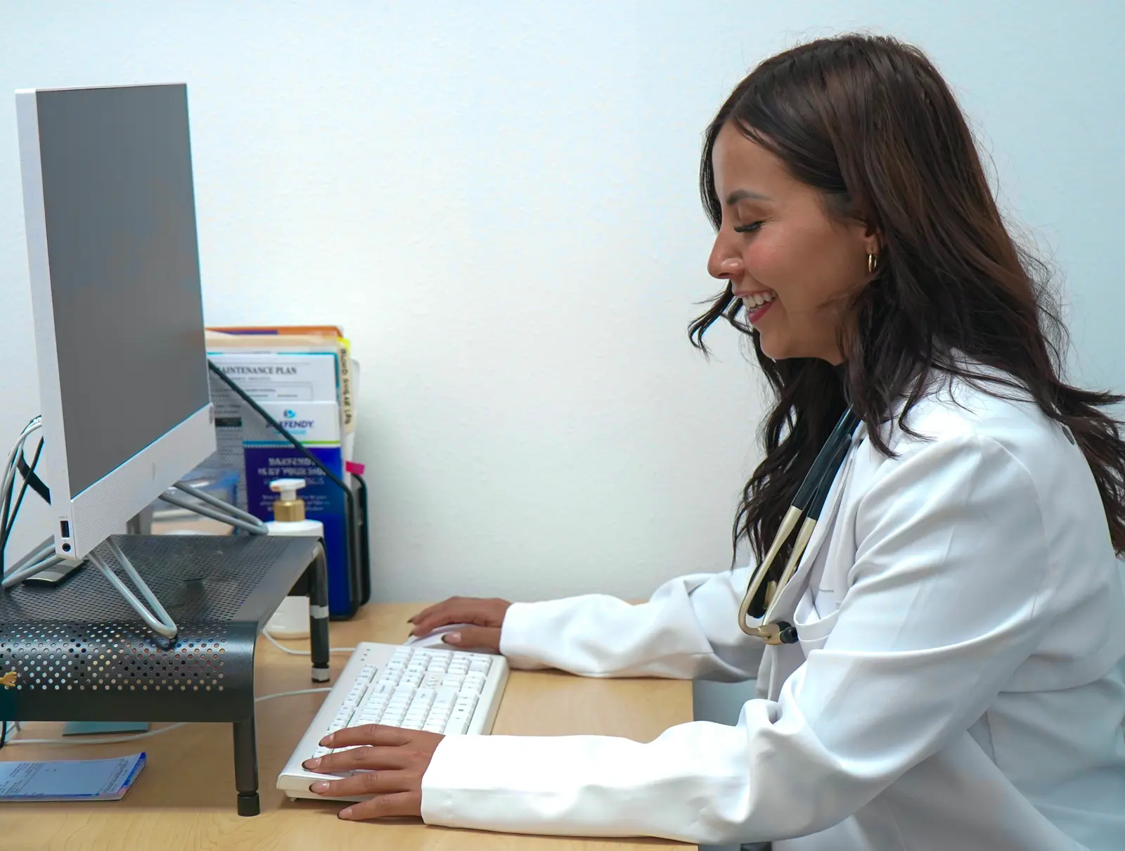 A Premier Clinic provider working at a clinic computer