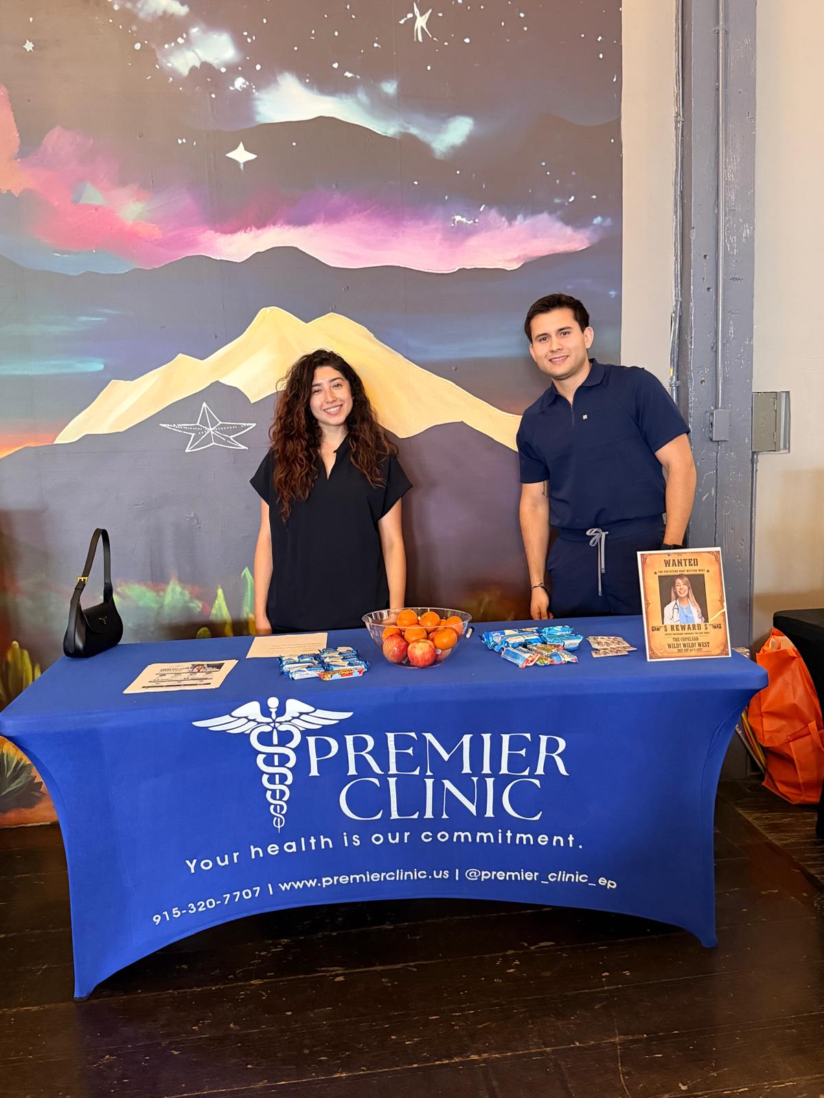 Premier team behind their branded table at a community event